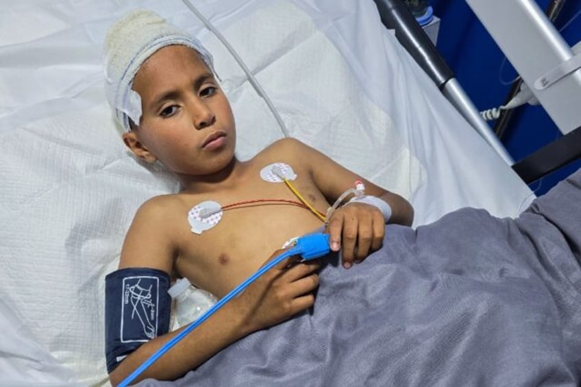 Mohamed Farhat, 10, is treated in a Tripoli hospital for injuries caused by an unexploded