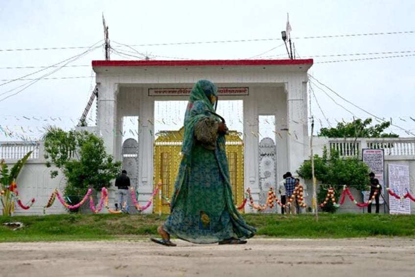 A woman walks past the ashram of preacher Bhole Baba at Bichhawan village in Mainpuri dist