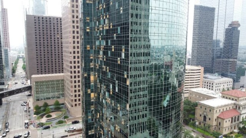 Shattered windows are seen on buildings in downtown Houston on May 17, 2024, one day after