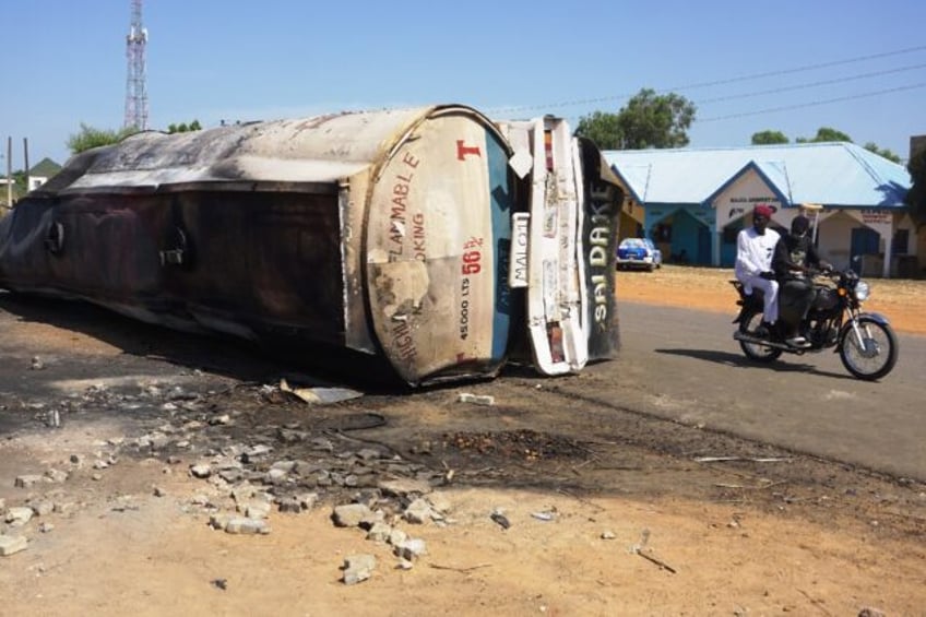 An explosion tore through crowds of people who had rushed to collect fuel spilling from a