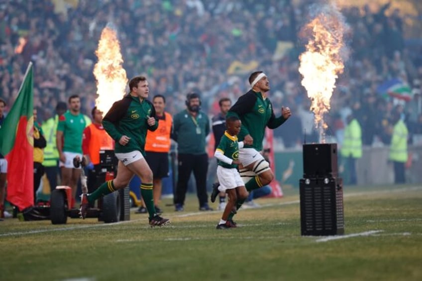 New South Africa captain Salmaan Moerat (R) leads out his team against Portugal.