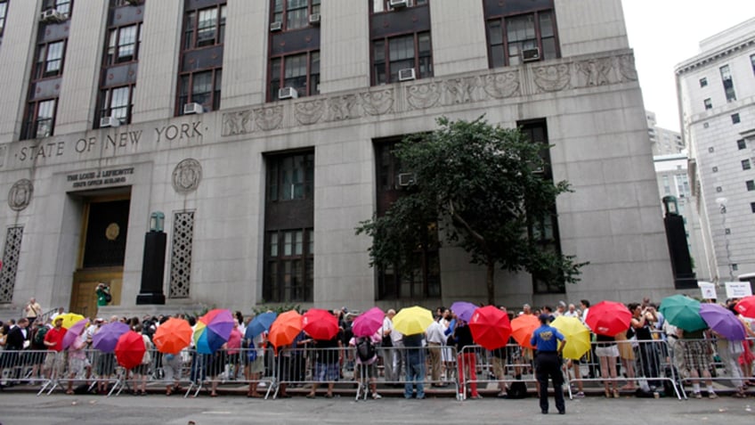 Same-sex couples stand in line to receive wedding licenses. 