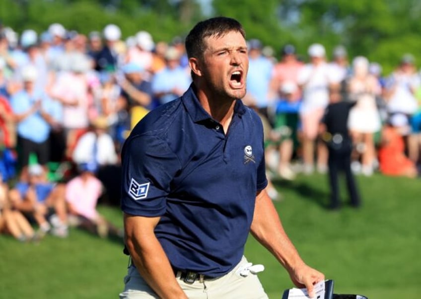 American Bryson DeChambeau roars after sinking a 10-foot birdie putt at the 18th hole to s