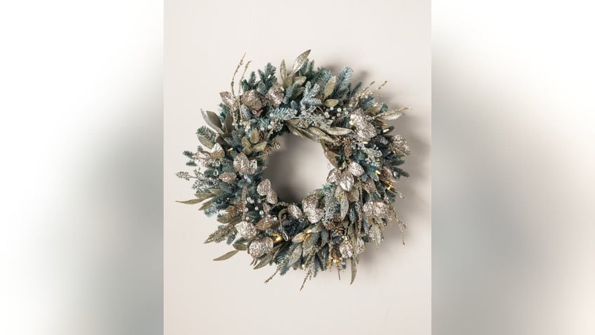 A fancy flocked wreath creates a magical wintry aesthetic to adorn your front door.