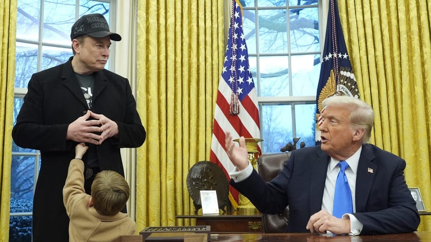 President Donald Trump speaks as Elon Musk, joined by his son X Æ A-Xii, listens in the Oval Office at the White House, Tuesday, Feb. 11, 2025, in Washington. (Photo/Alex Brandon)