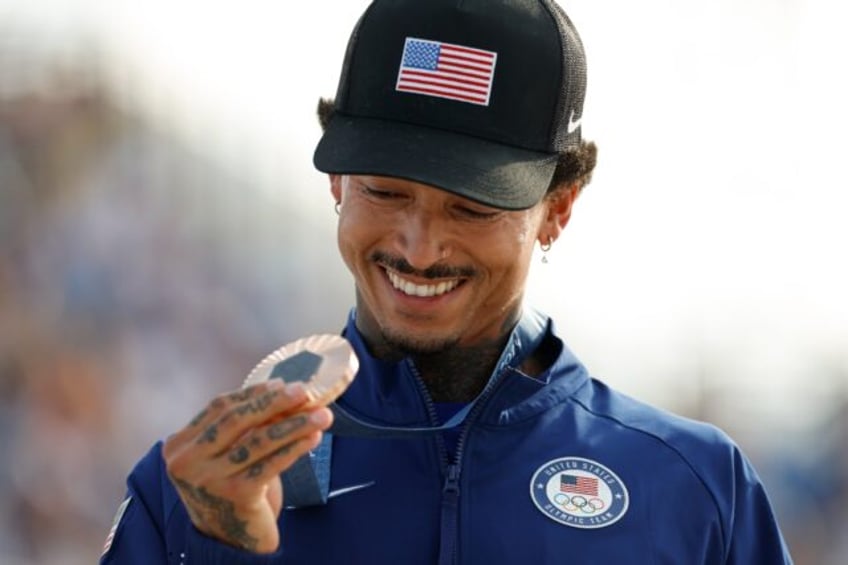 Nyjah Huston holds his bronze medal after the victory ceremony for the men's street skateb