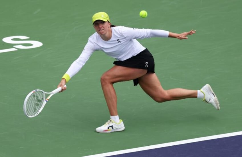 Iga Swiatek of Poland plays a forehand on the way to a quarter-final victory over China's
