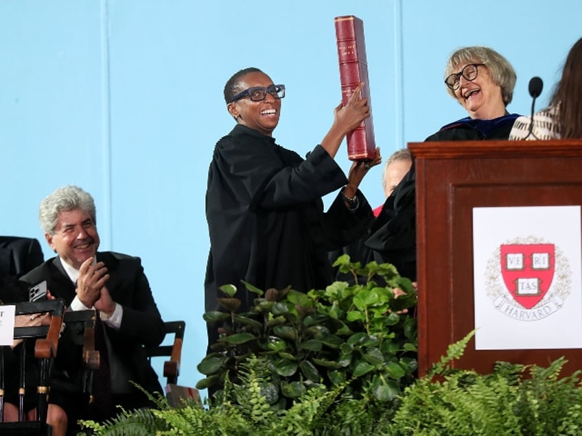 Claudine Gay holding a giant book