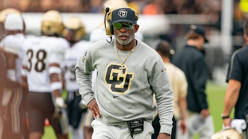 Deion Sanders stands on the sidelines