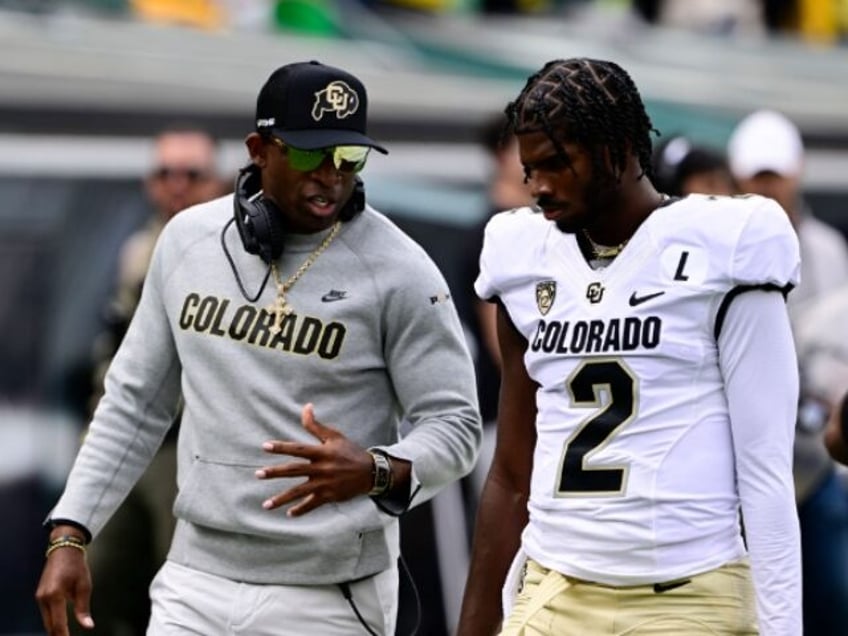 EUGENE, OR - SEPTEMBER 23: Colorado Buffaloes head coach Deion Sanders talks with his son