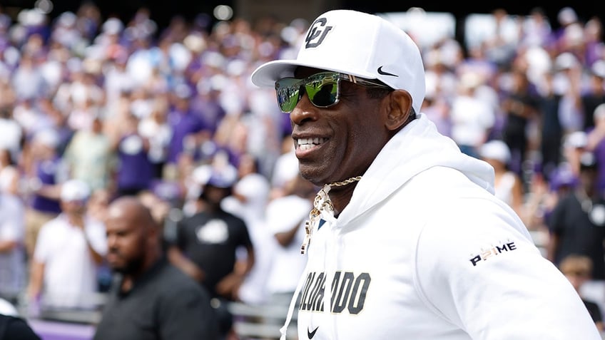 Deion Sanders runs on to the field