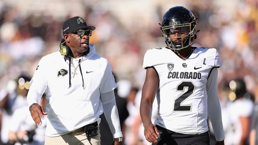 Deion and Shedeur Sanders walk on field