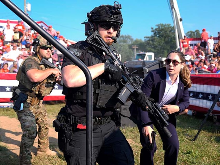 U.S. Secret Service agents respond as Republican presidential candidate former President Donald Trump is surrounded on stage by U.S. Secret Service agents at a campaign rally, Saturday, July 13, 2024, in Butler, Pa. (AP Photo/Evan Vucci)