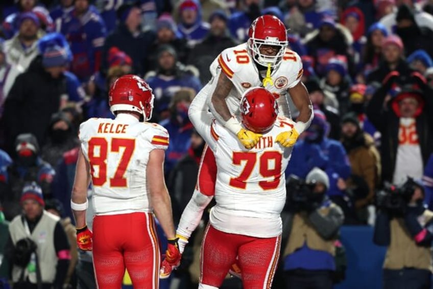 Isiah Pacheco #10 of the Kansas City Chiefs celebrates with Donovan Smith #79 after scoring a touchdown against the Buffalo Bills during the fourth quarter in the AFC Divisional playoff game at Highmark Stadium on Sunday.