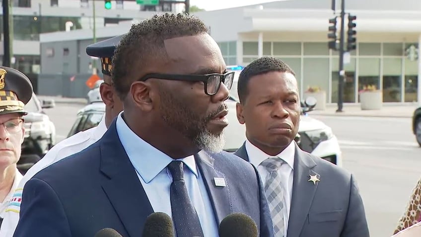 Chicago Mayor Brandon Johnson talks to reporters