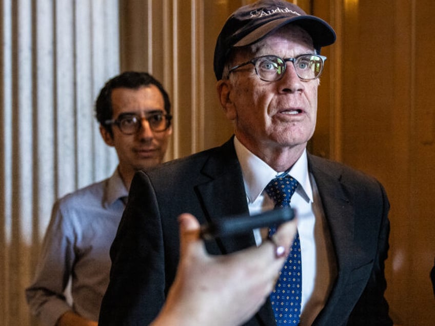 Sen. Peter Welch (D-VT) is questioned by reporters as he departs the Senate floor followin