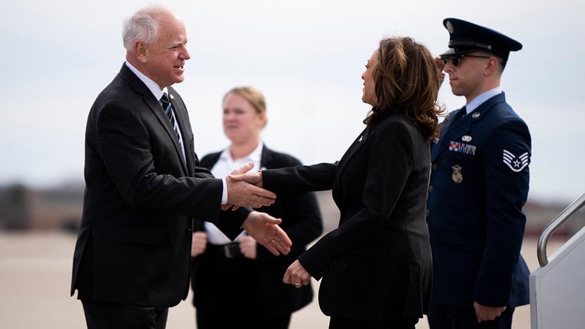 Tim Walz shaking VP Harris' hand on tarmac