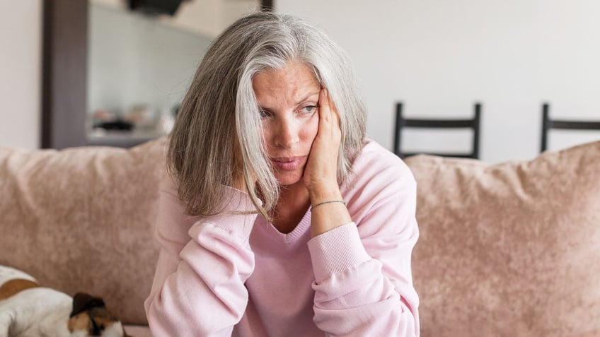 Woman sad on couch