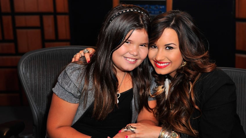 Madison De La Garza and Demi Lovato posing together