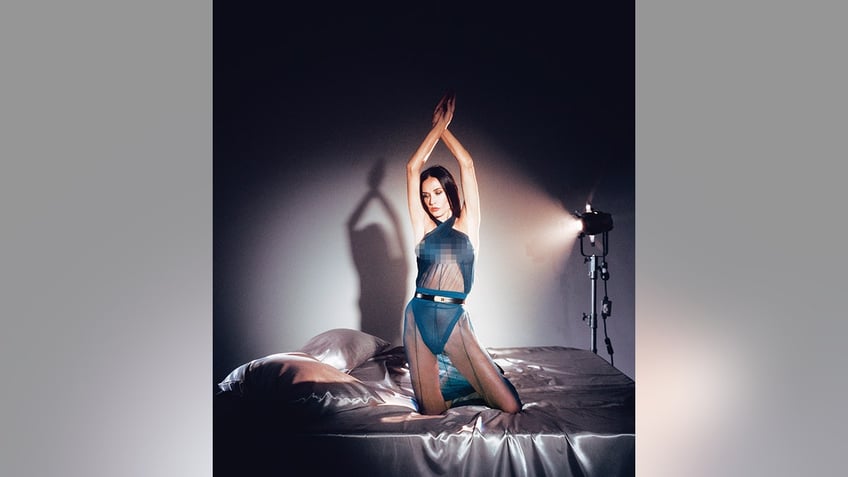 Demi Moore posing on a bed