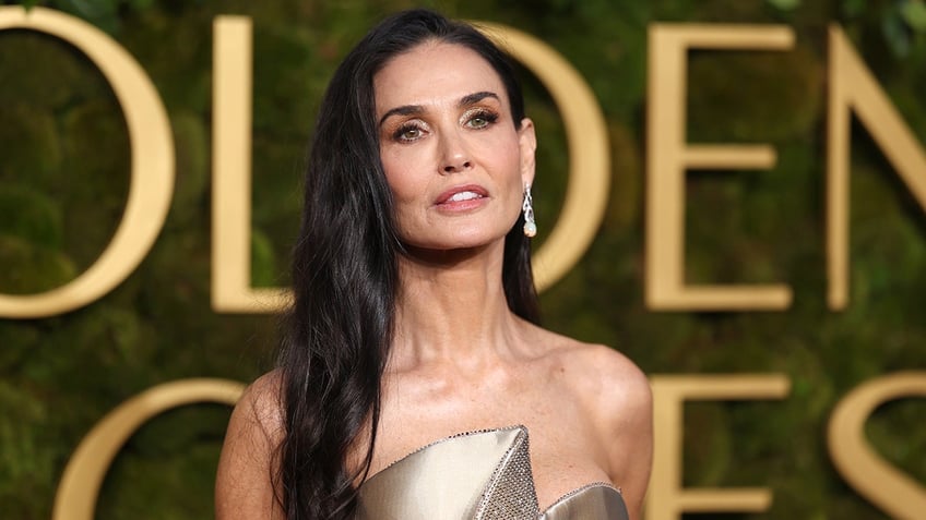 Demi Moore wears strapless silver dress at Golden Globes.