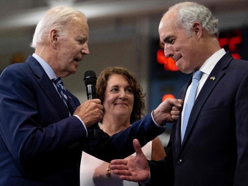 US President Joe Biden (L) arrives with US Senator Bob Casey (R) and his wife Terese (C) t