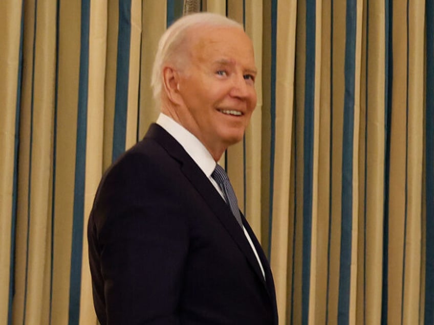 U.S. President Joe Biden pauses to react to a reporter's question as he leaves the St