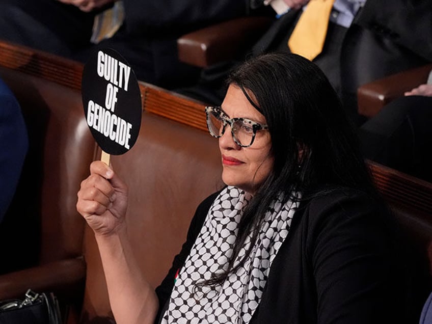 Rep. Rashida Tlaib, D-Mich., holds a sign as she attends a speech by Israeli Prime Ministe