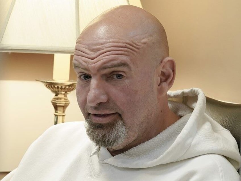 Sen. John Fetterman, D-Pa., sits before a news conference on the debt limit, Thursday, May