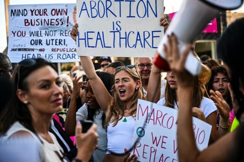 Abortion rights activists rally after the US Supreme Court striked down the right to abort