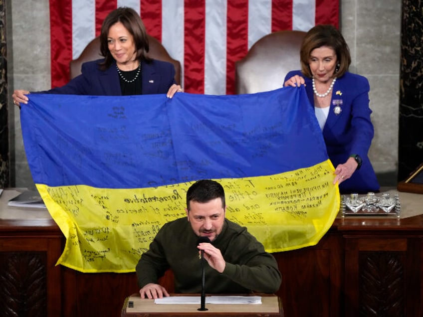 Vice President Kamala Harris and House Speaker Nancy Pelosi of Calif., right, hold up a Uk