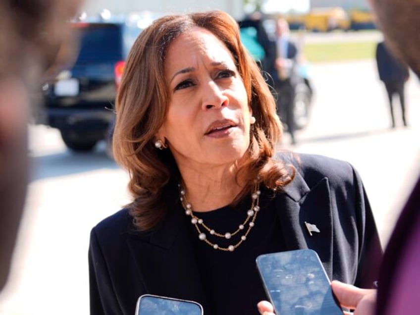 Democratic presidential nominee Vice President Kamala Harris talks to the media before boa