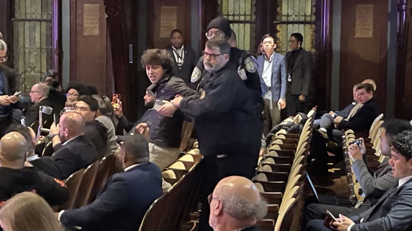 A protester is removed by security after heckling at a Democratic National Committee chair election debate at Georgetown University in Washington, D.C., on Jan. 30, 2025.