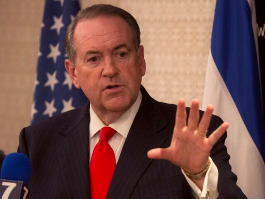 Republican presidential hopeful Mike Huckabee gestures as he speaks during a press confere