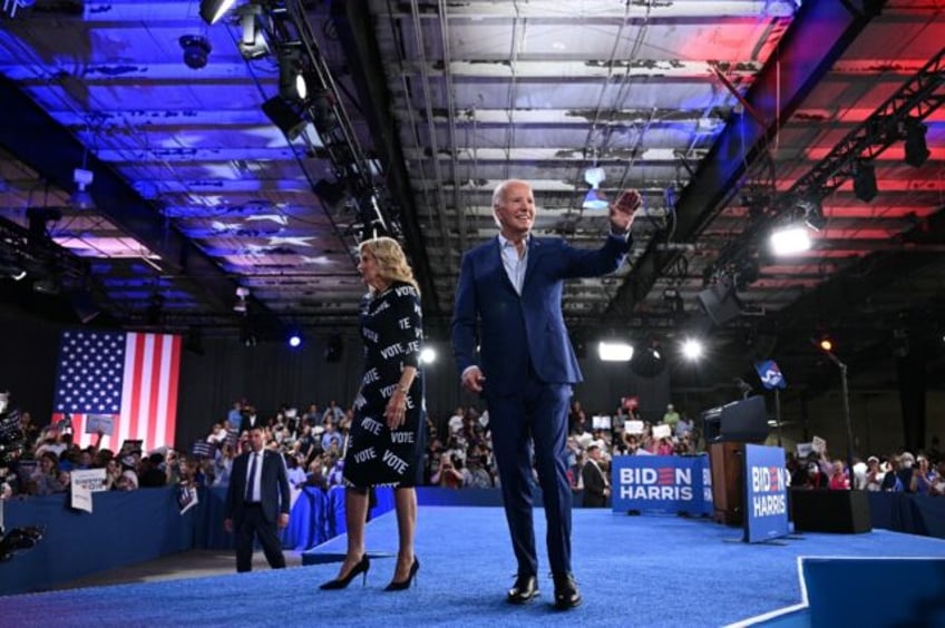 US President Joe Biden and First Lady Jill Biden walk off the stage after a campaign event