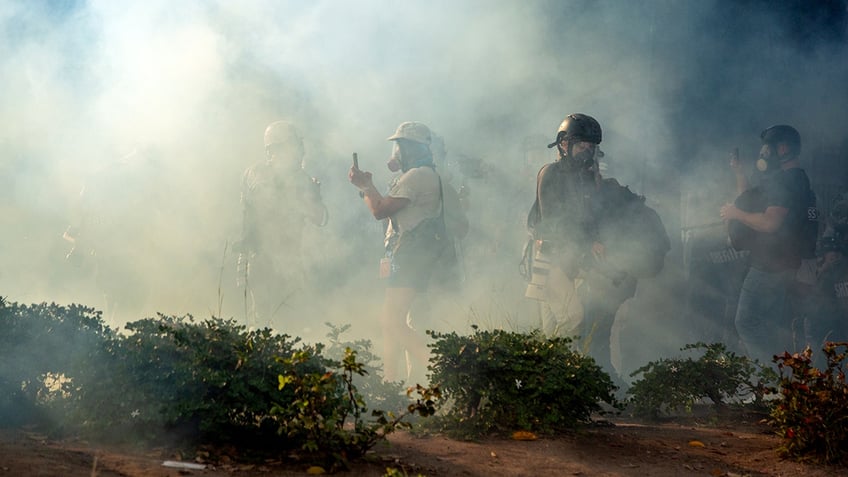 Gas masked people at anti-ICE riots in Los Angeles.