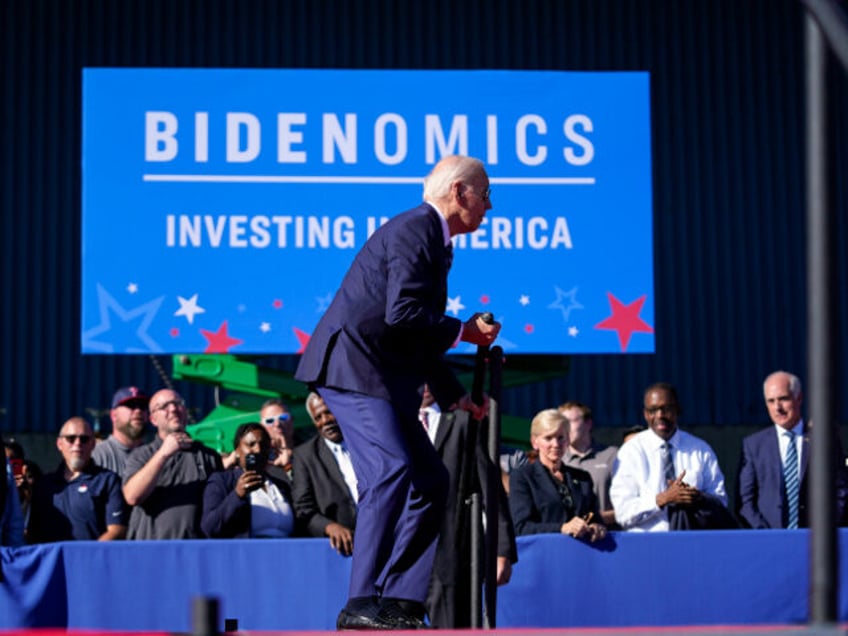 President Joe Biden jokes around after stumbling on stage at Tioga Marine Terminal, Friday