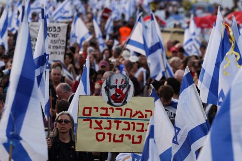 Israeli anti-government protesters rally in front of parliament demanding premier Benjamin