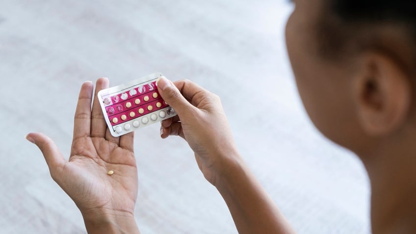 woman taking birth control pill