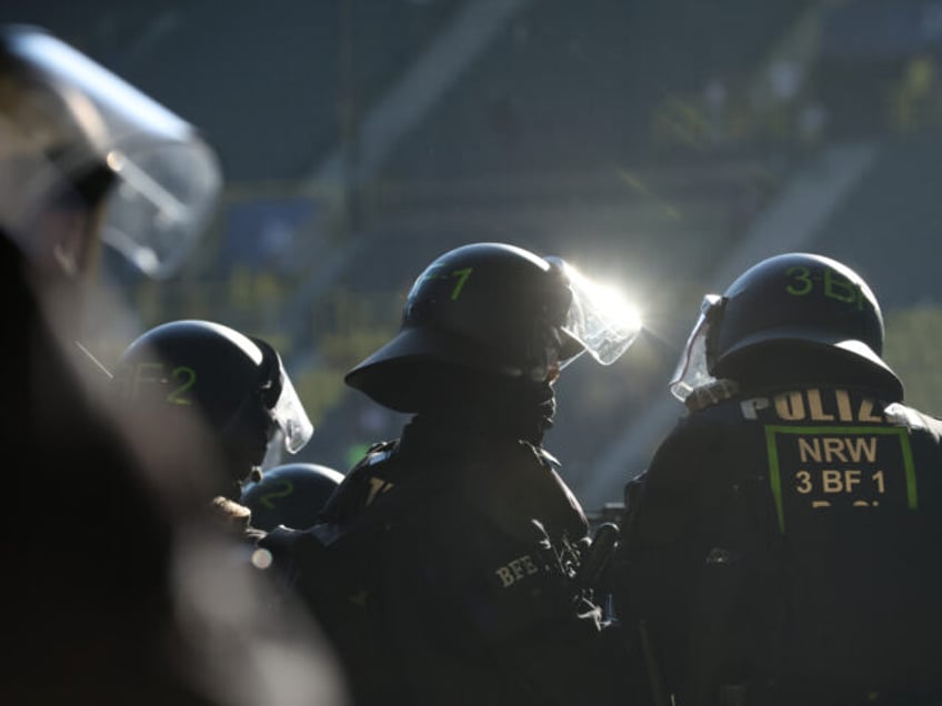 DORTMUND, GERMANY - SEPTEMBER 06: Riot police watches fans of Copenhagen cheer prior to th