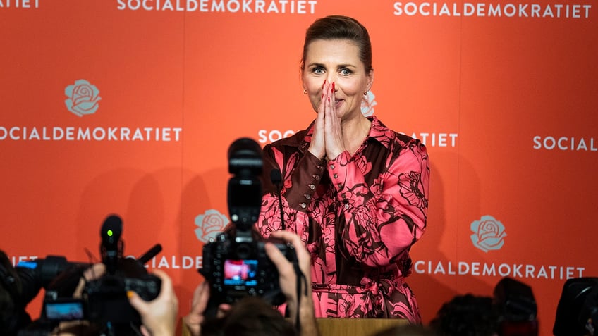 Denmark's PM Mette Frederiksen puts hands over face in shock