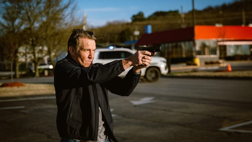 Dennis Quaid pointing a gun in the movie "Sovereign"