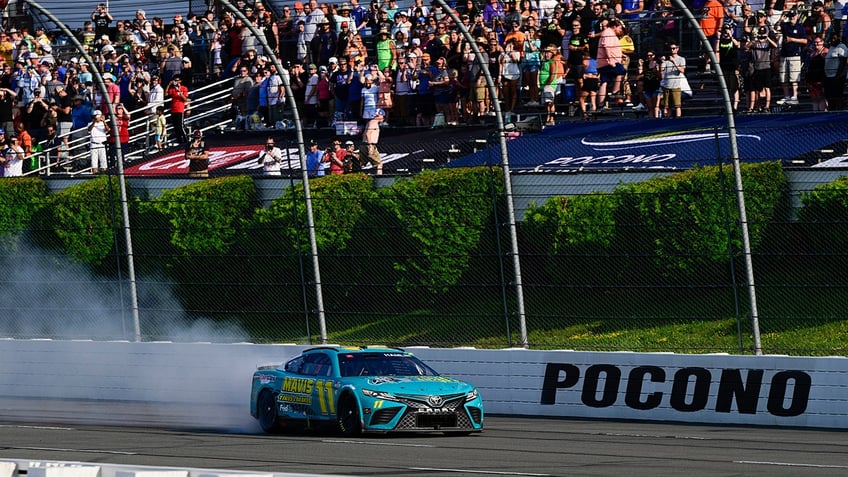 denny hamlin faces boos from nascar fans during pocono win irks kyle larson over move