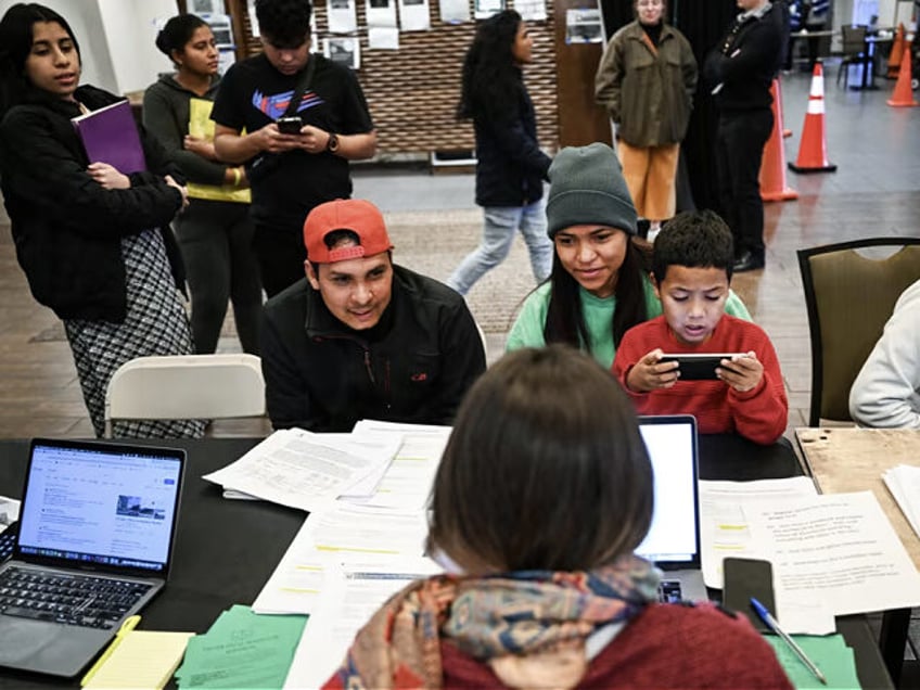 DENVER, CO - FEBRUARY 5: Volunteer Nina Frias, with back to camera, with Juntos Center, wo