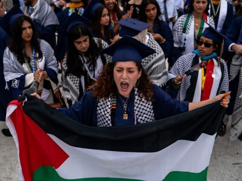 WASHINGTON, DC - MAY 19: Students protest as they walk out from the George Washington Univ