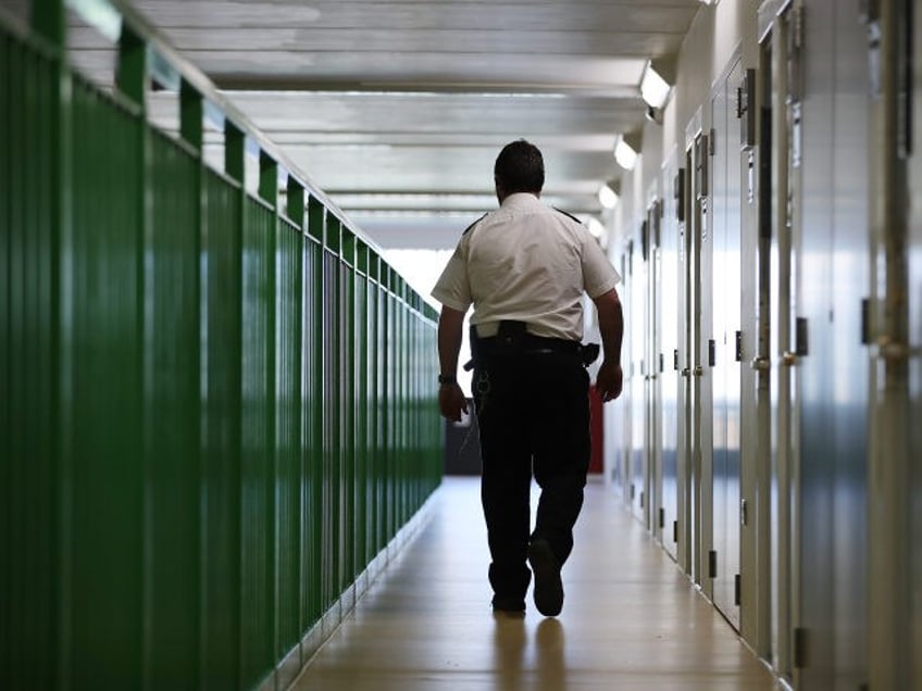 WREXHAM, WALES - MARCH 15: A prison guard walks through a cell area at HMP Berwyn on March 15, 2017 in Wrexham, Wales. The mainly category C prison is one of the biggest jails in Europe capable of housing around to 2,100 inmates. (Photo by Dan Kitwood/Getty Images)