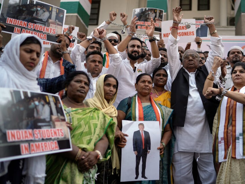 Congress party workers, some of them wearing shackles, protest to condemn the reported mis