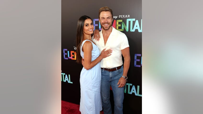 Derek Hough and Hayley Erbert posing on the red carpet