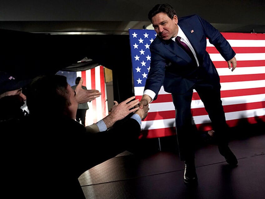 Ron DeSantis, governor of Florida and 2024 Republican presidential candidate, right, arrives for a caucus night watch party in West Des Moines, Iowa, US, on Monday, Jan. 15, 2024. DeSantis finished second in the Iowa Republican caucuses, AP says, defying expectations of a weaker showing after polls showed the Florida …