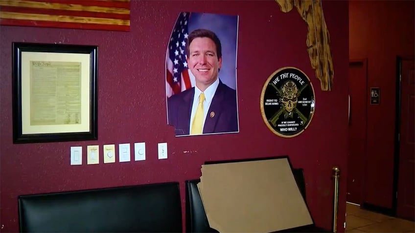 desantis photo displayed in bar damaged after suspect took it into restroom